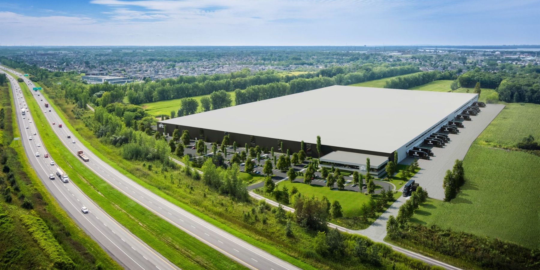 Un grand centre de distribution entouré de champs — un site industriel carboneutre